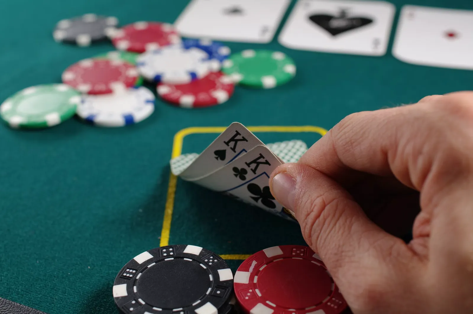 A close-up of a strategy card game in play on a green table