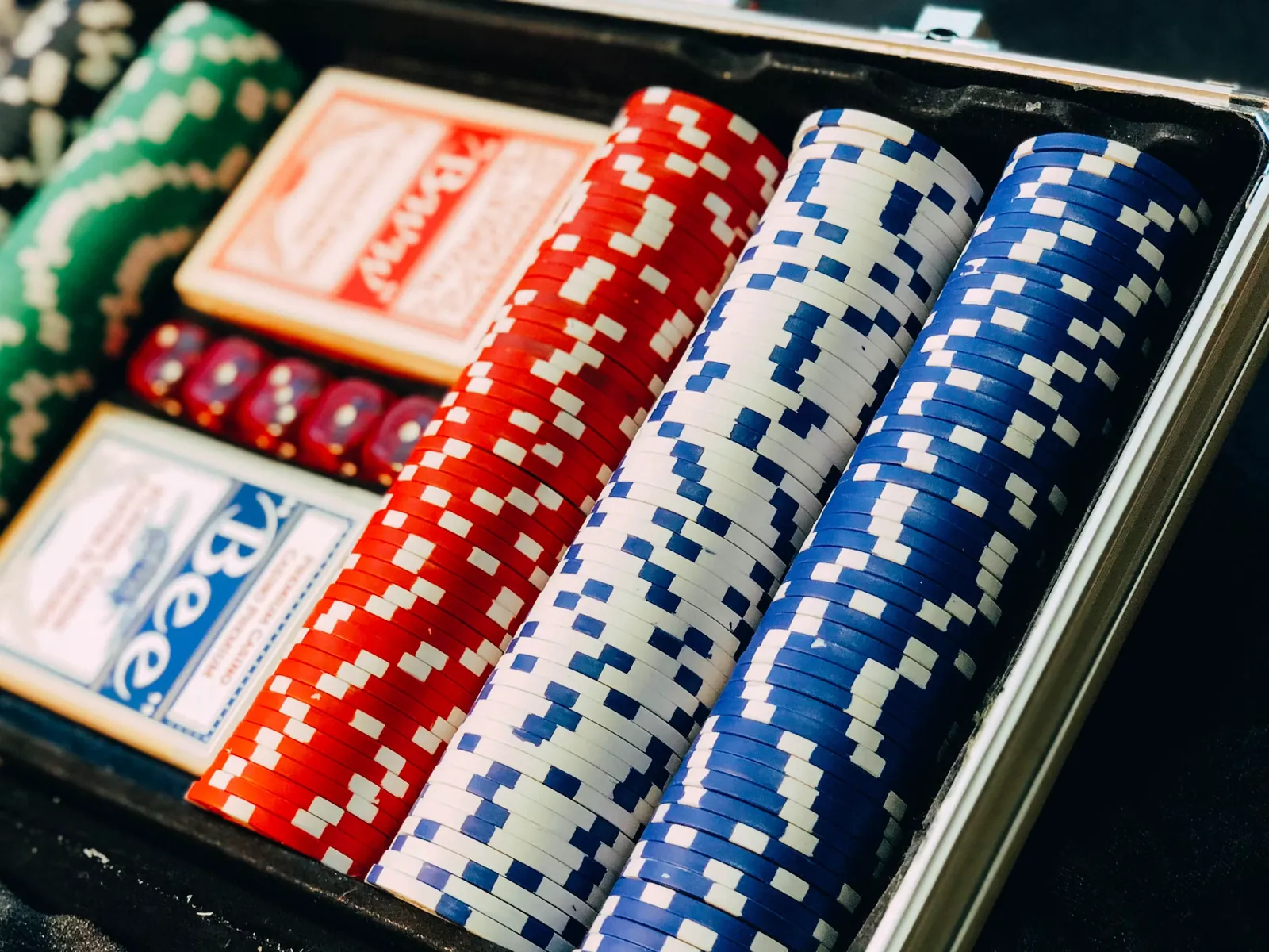 A neatly arranged set of red, white and blue game chips and cards